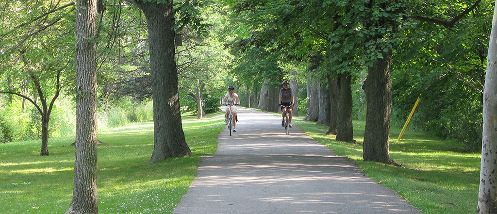 man and women biking down the pathway