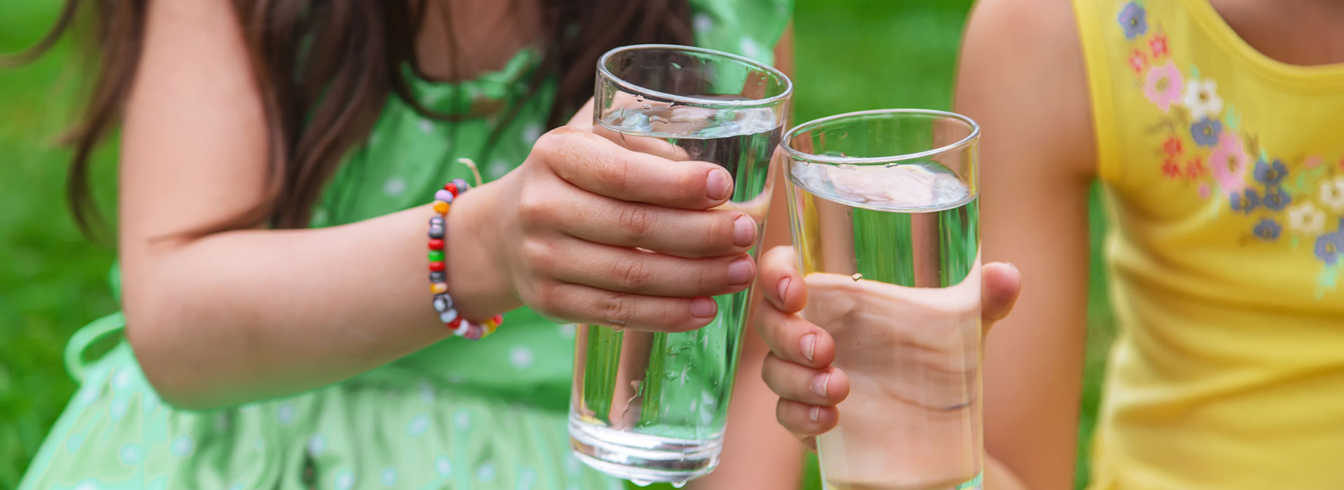 image of young girl drinking a glass water
