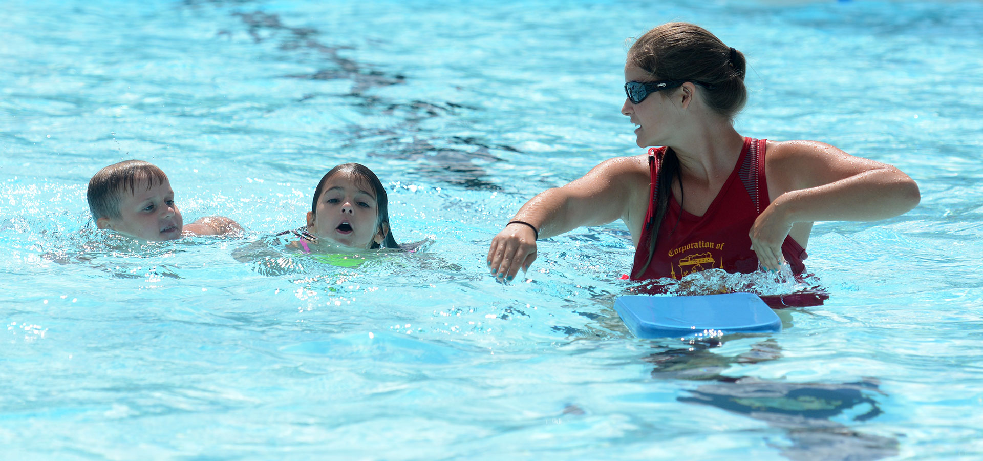 image of kids and a lifeguard in a pool 